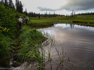 A group of  anglers hike by a tundra pond in Alaska's Legendary Bristol Bay Region