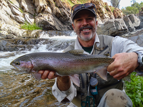 A creeks on the west side of the Sierras with Michael Carl holding large wild rainbow trout.